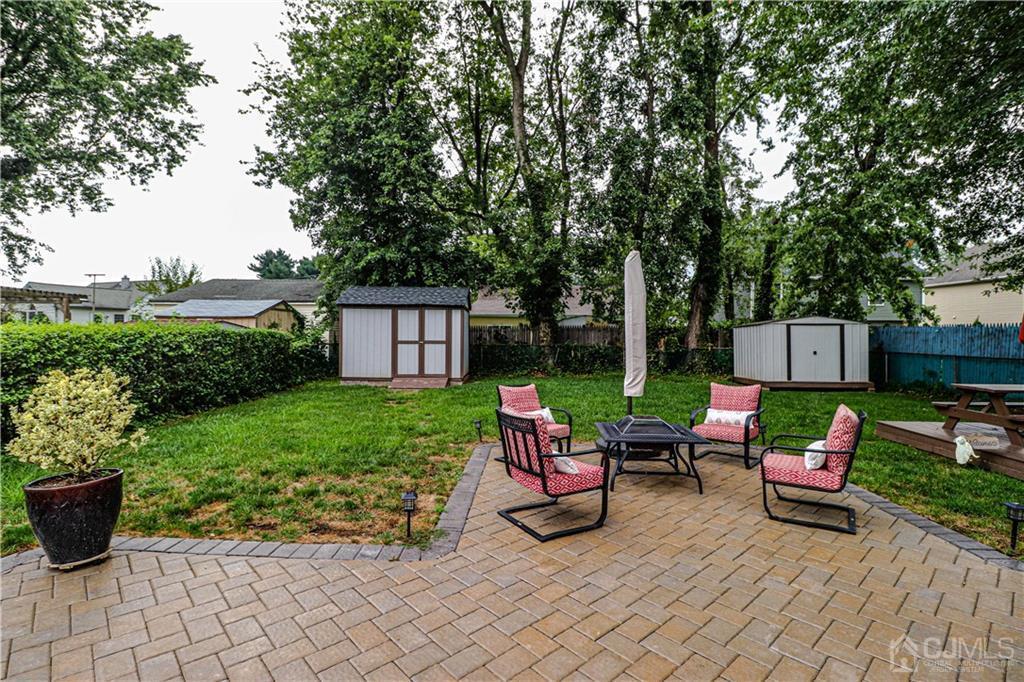 90 Ashley Road Edison, NJ 08817 - Photo 29 of 32 a view of a house with backyard sitting area and garden