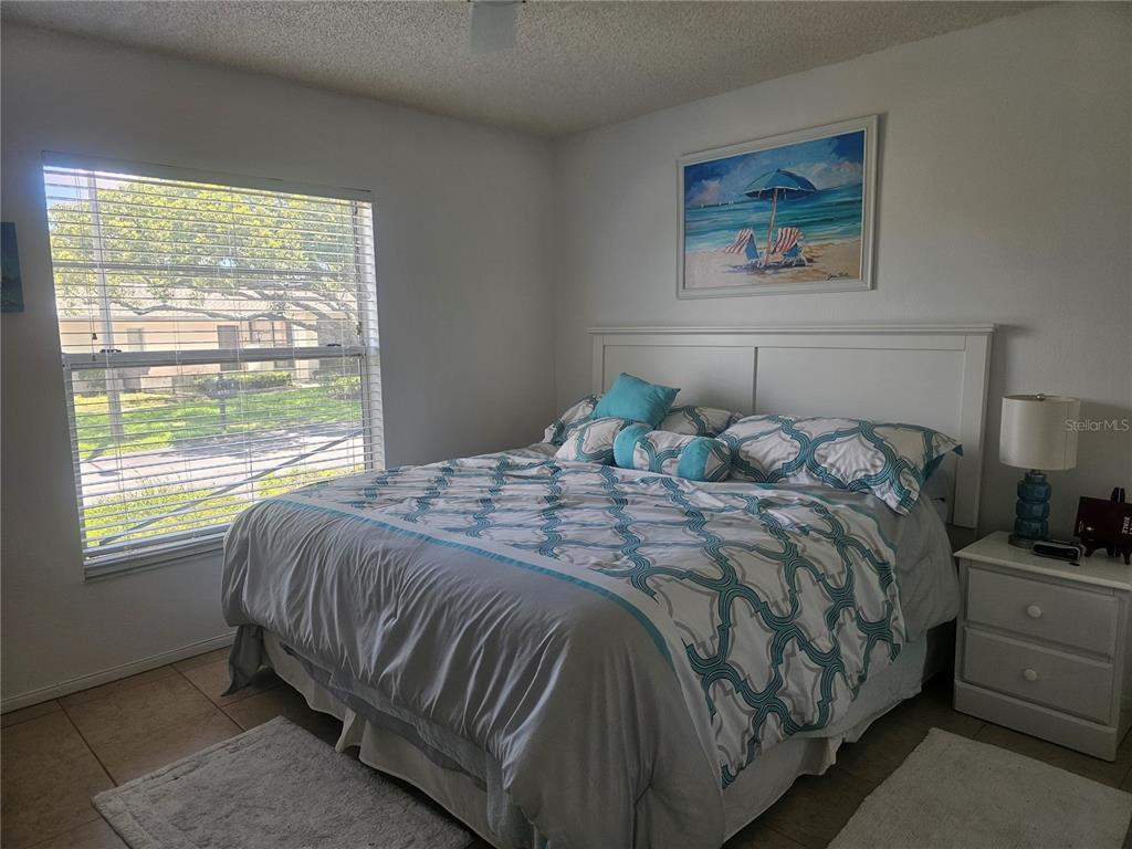 8150 Braddock Circle, Unit 3 Port Richey, FL 34668 - Photo 15 of 23 a bedroom with a bed and window