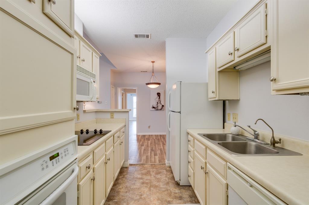 2100 Randy Snow Road, Unit 412 Arlington, TX 76011 - Photo 14 of 32 a kitchen with cabinets a sink and appliances