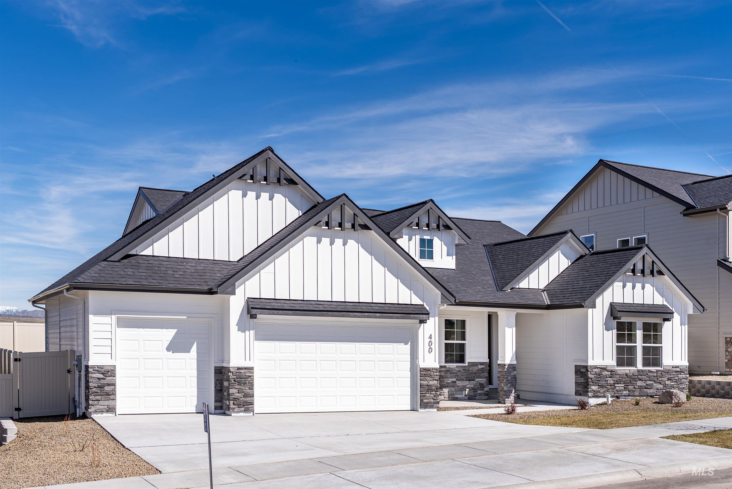 Modern farmhouse style home featuring roof with shingles, driveway, an attached garage, and board and batten siding