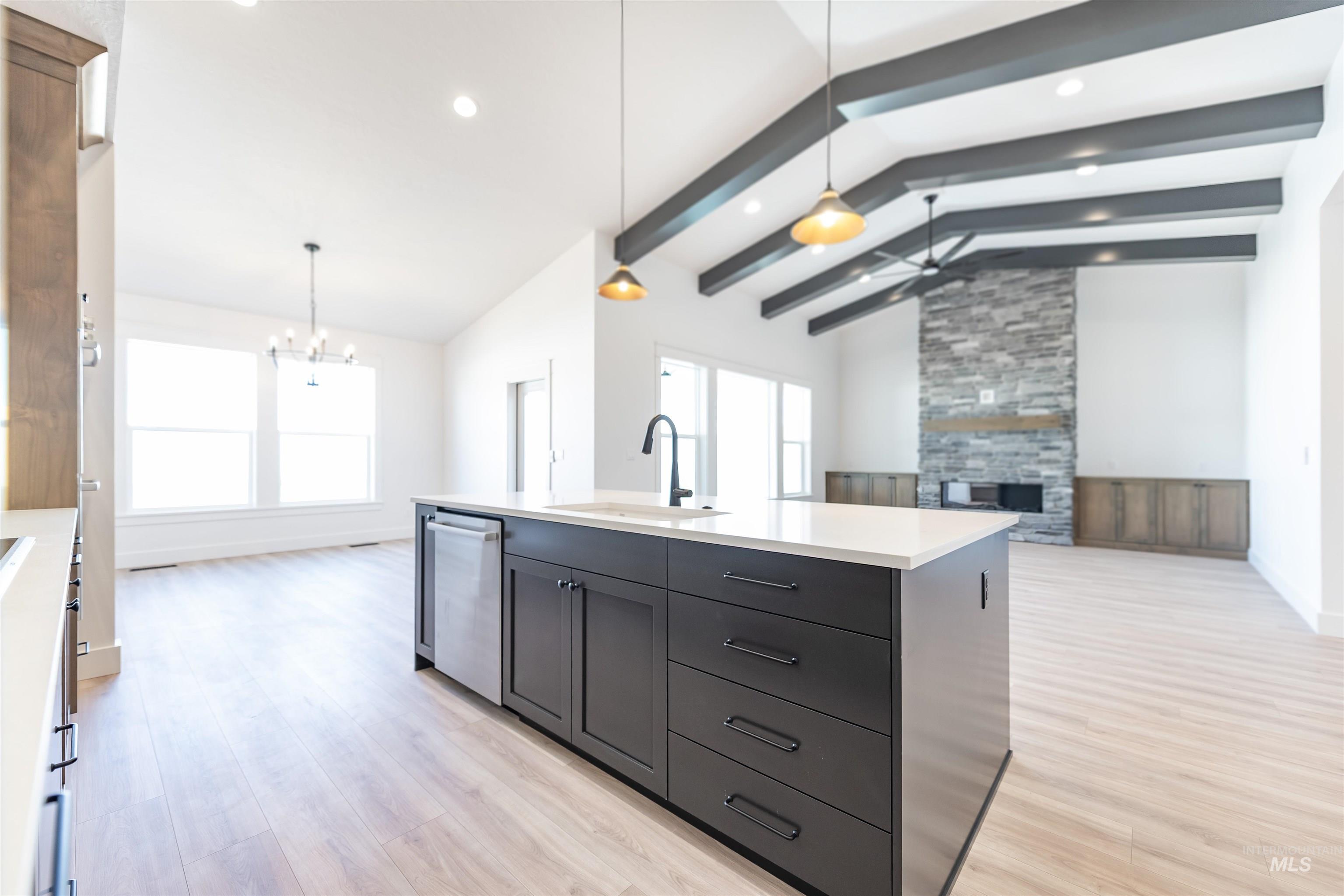 400 South Diesel Way Boise, ID 83716 - Photo 44 of 44 Kitchen with open floor plan, a tile fireplace, light wood-type flooring, beam ceiling, and an island with sink