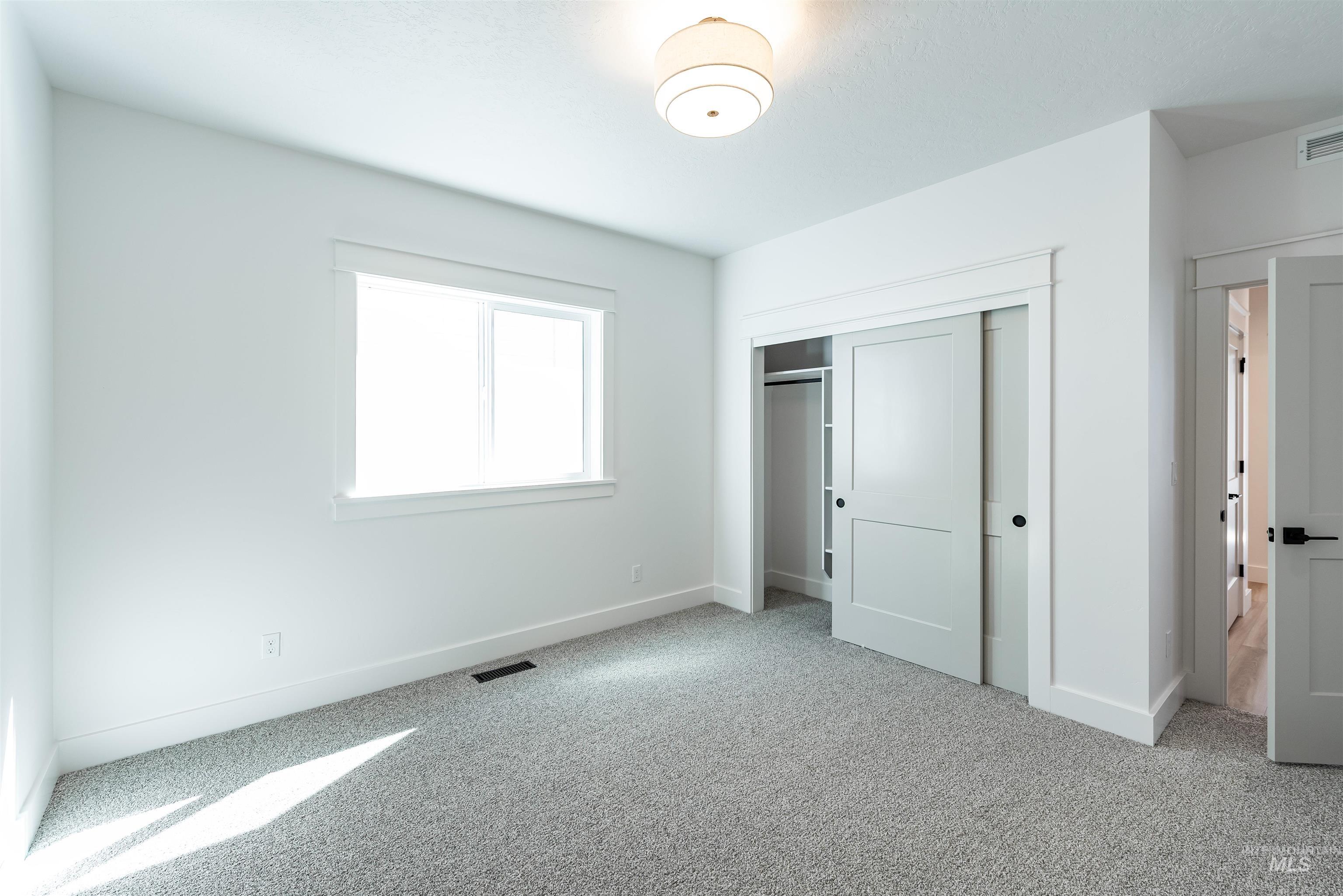 400 South Diesel Way Boise, ID 83716 - Photo 26 of 44 Unfurnished bedroom with light colored carpet and a closet