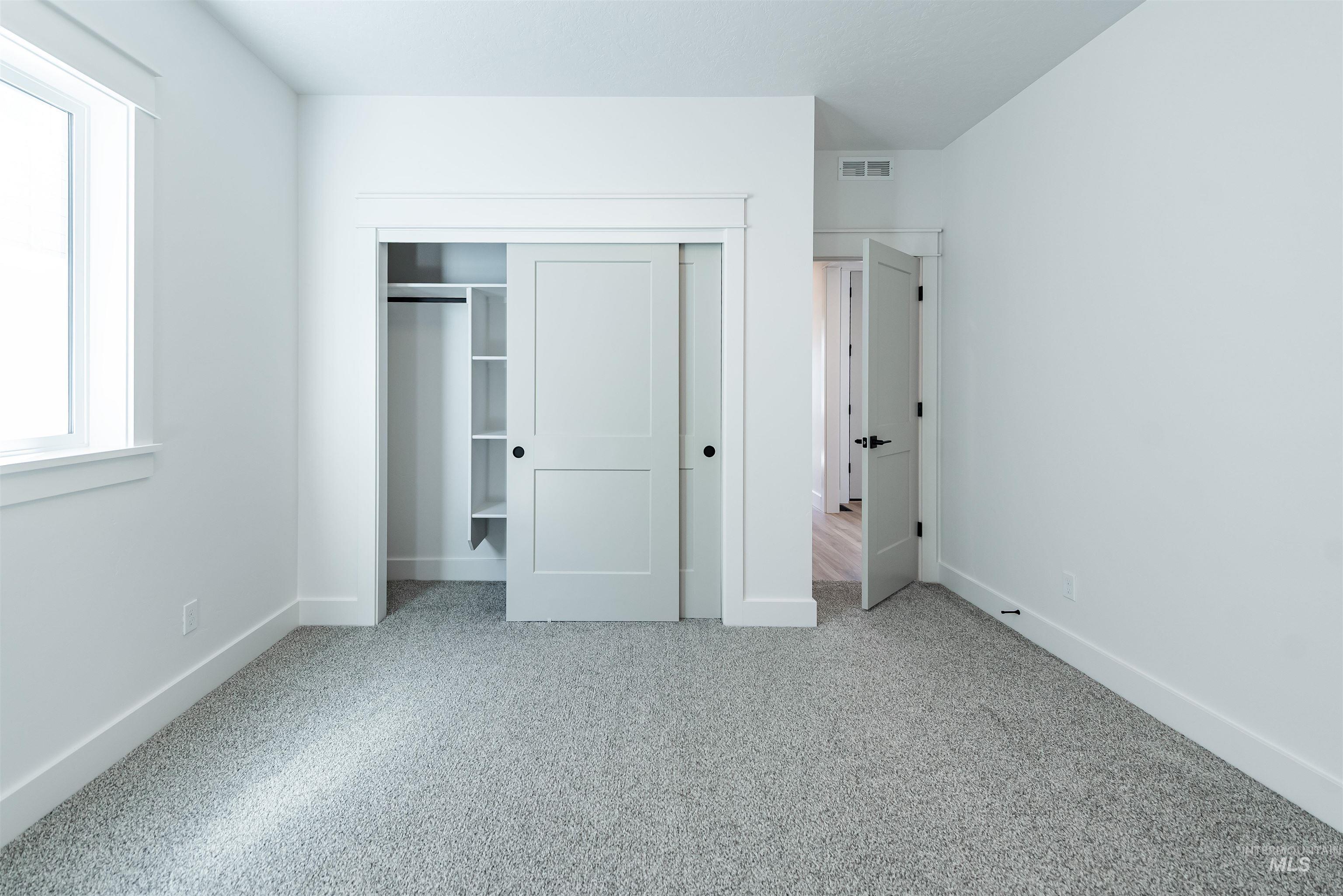 400 South Diesel Way Boise, ID 83716 - Photo 27 of 44 Unfurnished bedroom with light colored carpet and a closet