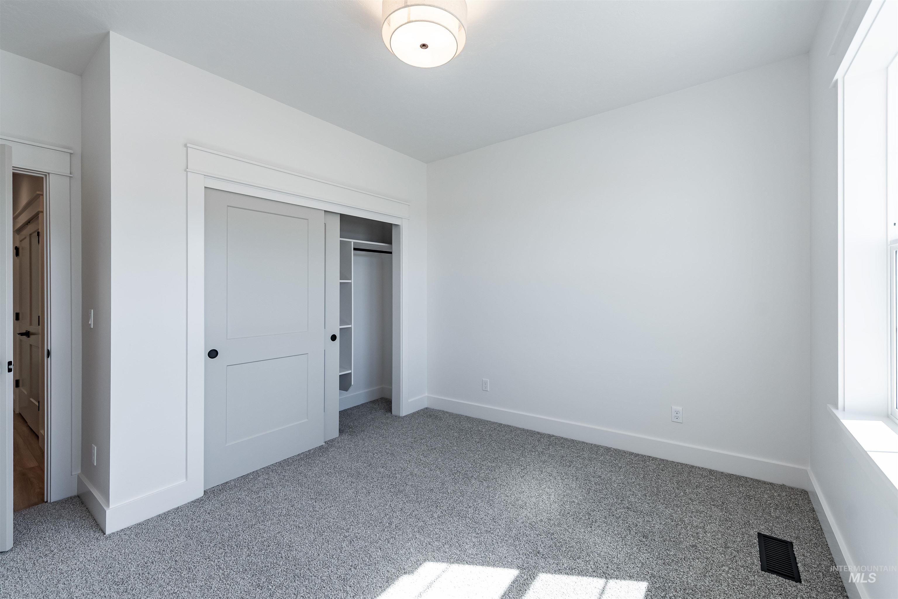 400 South Diesel Way Boise, ID 83716 - Photo 31 of 44 Unfurnished bedroom featuring light carpet and a closet