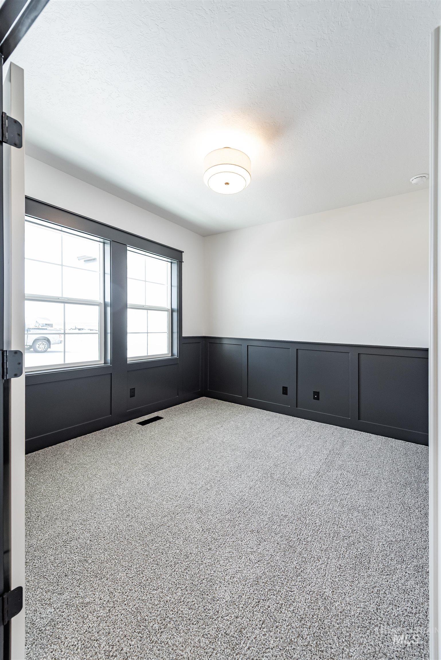 400 South Diesel Way Boise, ID 83716 - Photo 32 of 44 Carpeted empty room featuring a wainscoted wall, a decorative wall, and a textured ceiling