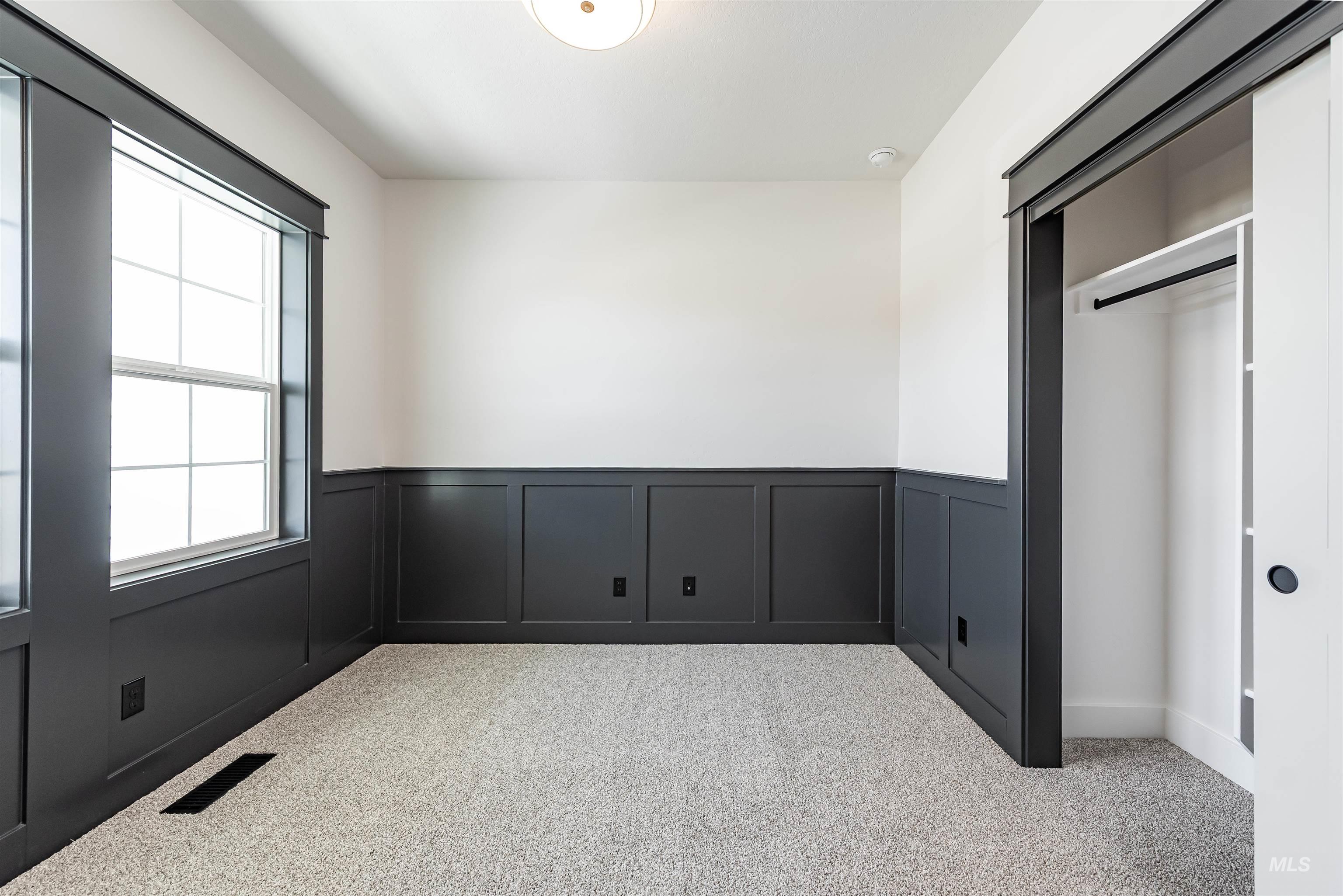 400 South Diesel Way Boise, ID 83716 - Photo 33 of 44 Unfurnished bedroom with carpet flooring, wainscoting, a decorative wall, and a closet