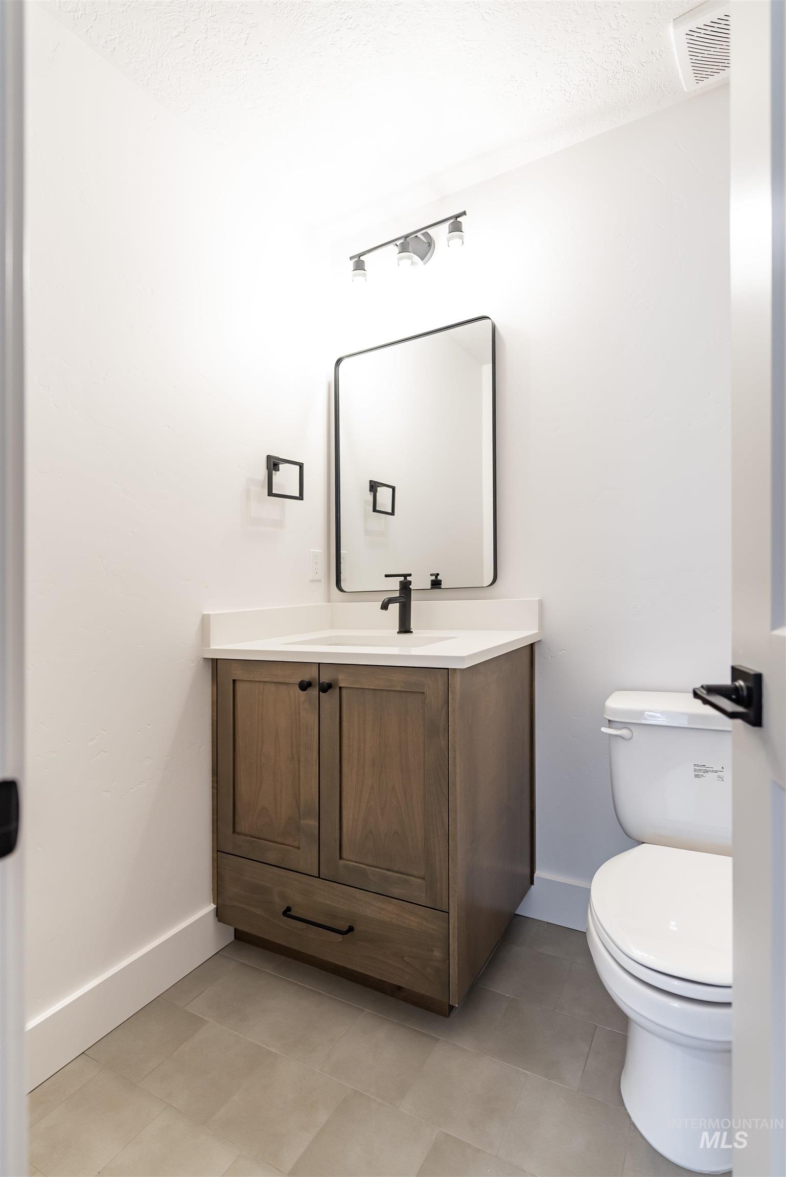 400 South Diesel Way Boise, ID 83716 - Photo 38 of 44 Bathroom with vanity, light tile patterned floors, and a textured ceiling