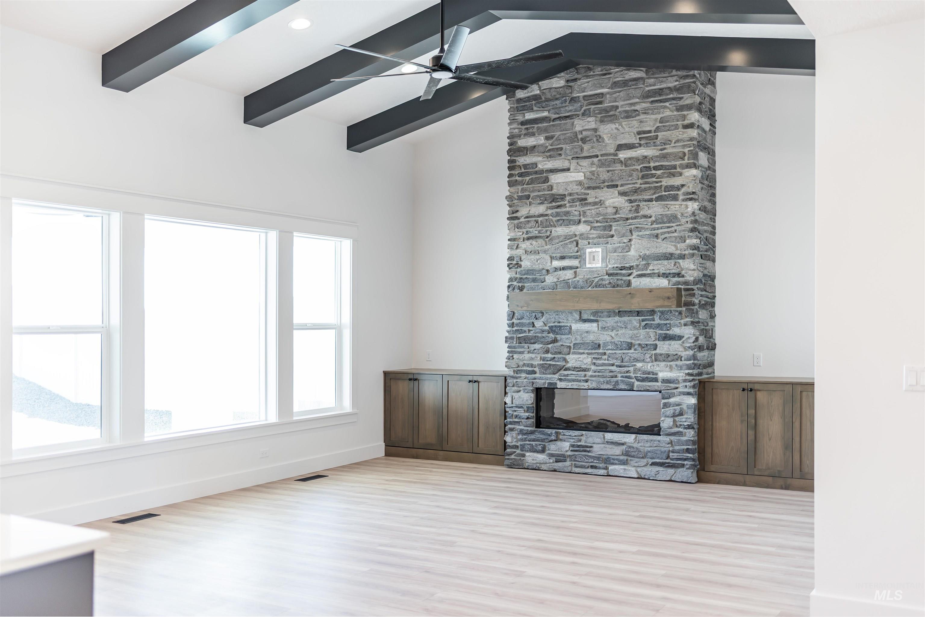 400 South Diesel Way Boise, ID 83716 - Photo 5 of 44 Unfurnished living room with a fireplace, light wood-type flooring, ceiling fan, vaulted ceiling, and recessed lighting