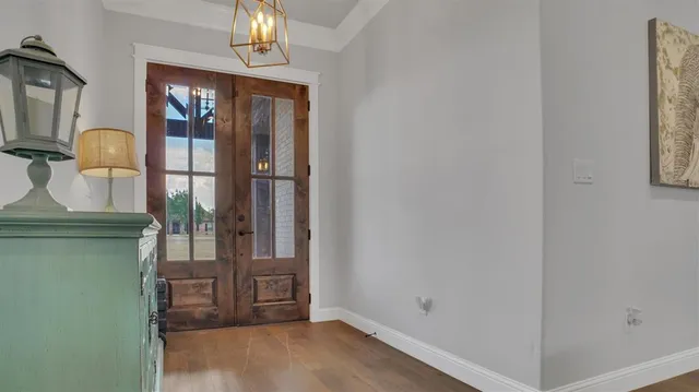 a view of a livingroom with wooden floor and cabinet