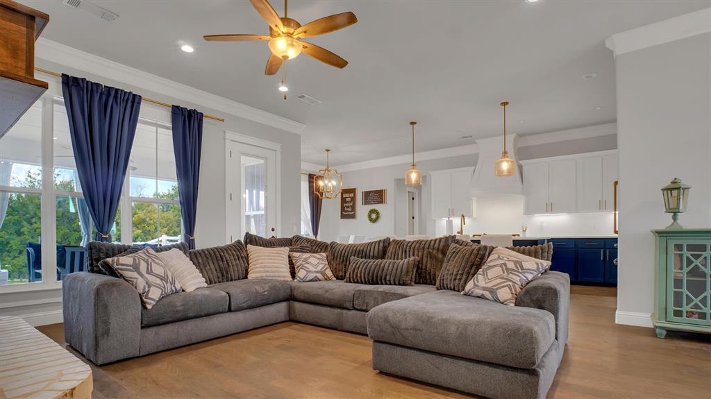 101 Sky Way New Fairview, TX 76078 - Photo 2 of 20 a living room with furniture a large window and a chandelier