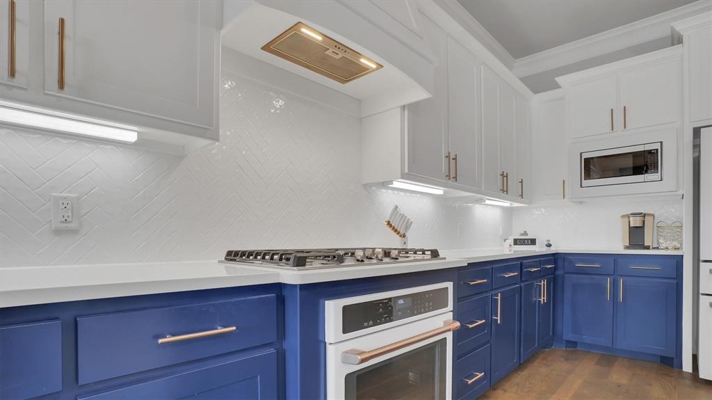 101 Sky Way New Fairview, TX 76078 - Photo 4 of 20 a kitchen with stainless steel appliances granite countertop a stove and a microwave