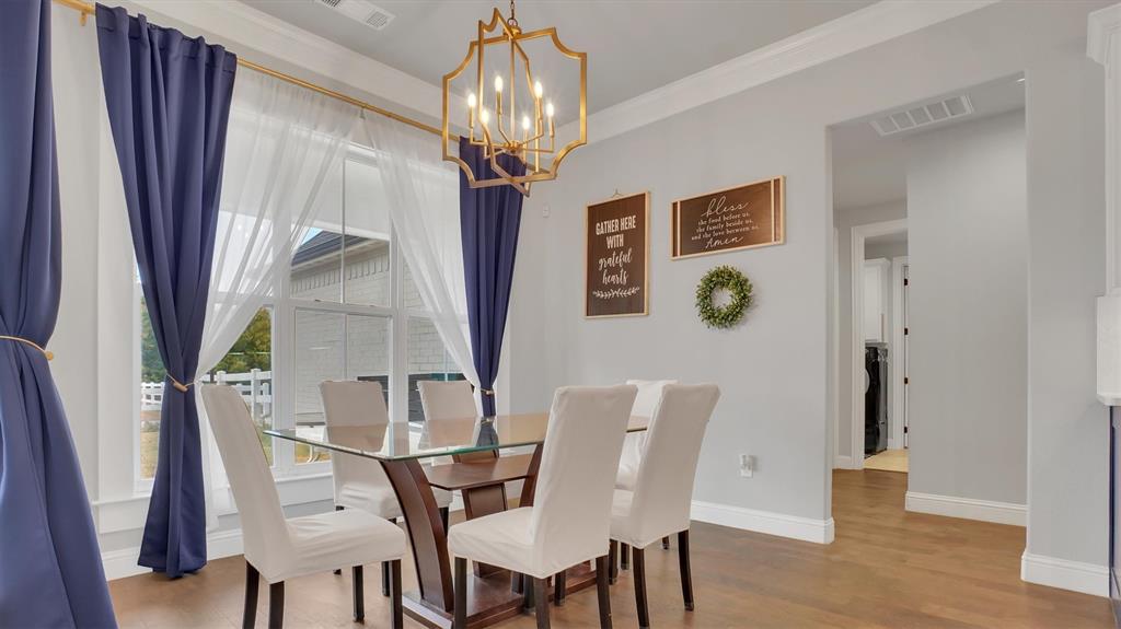 101 Sky Way New Fairview, TX 76078 - Photo 5 of 20 a view of a dining room with furniture wooden floor and chandelier