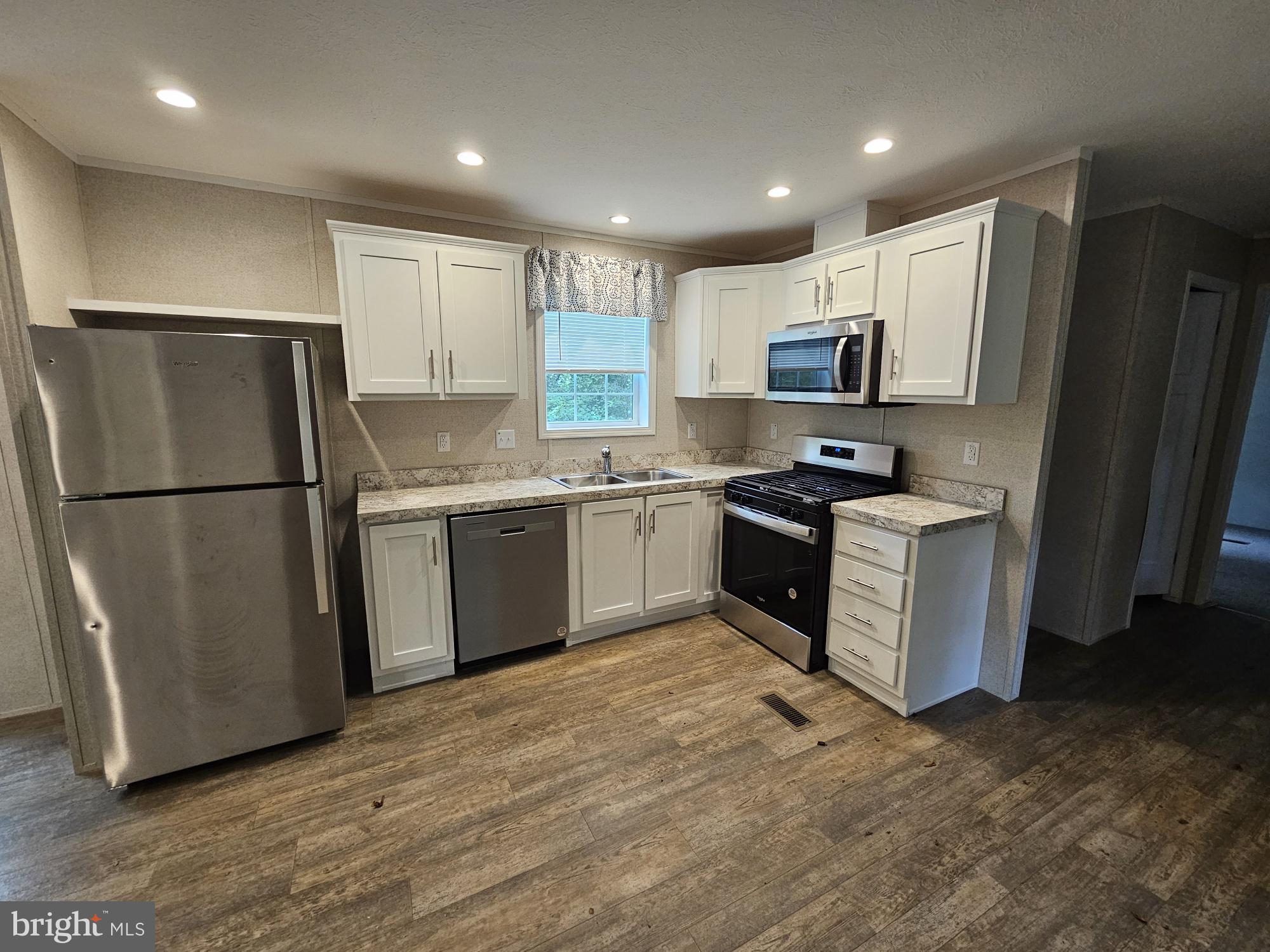 465 Royal Manor Road Easton, PA 18042 - Photo 2 of 14 a kitchen with a refrigerator a sink and cabinets