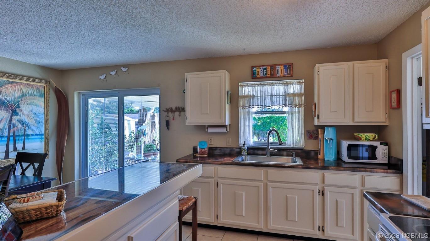 1861 Evergreen Drive Edgewater, FL 32141 - Photo 11 of 31 a kitchen with cabinets a window and a sink
