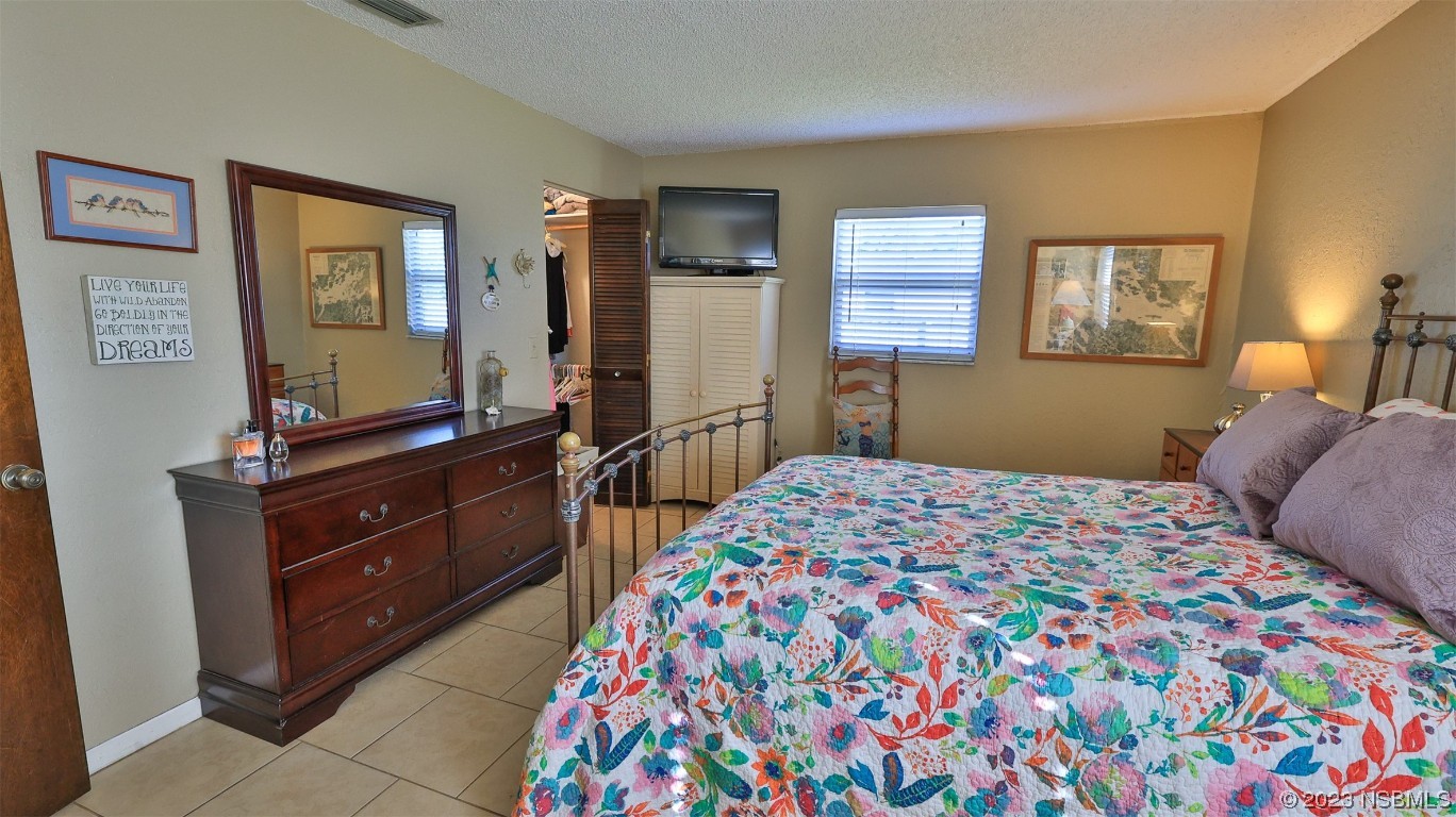 1861 Evergreen Drive Edgewater, FL 32141 - Photo 14 of 31 a bedroom with a bed and a dresser in it