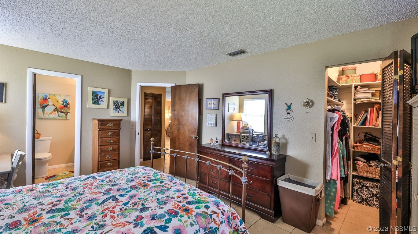 1861 Evergreen Drive Edgewater, FL 32141 - Photo 15 of 31 a bedroom with a bed and a dresser in it