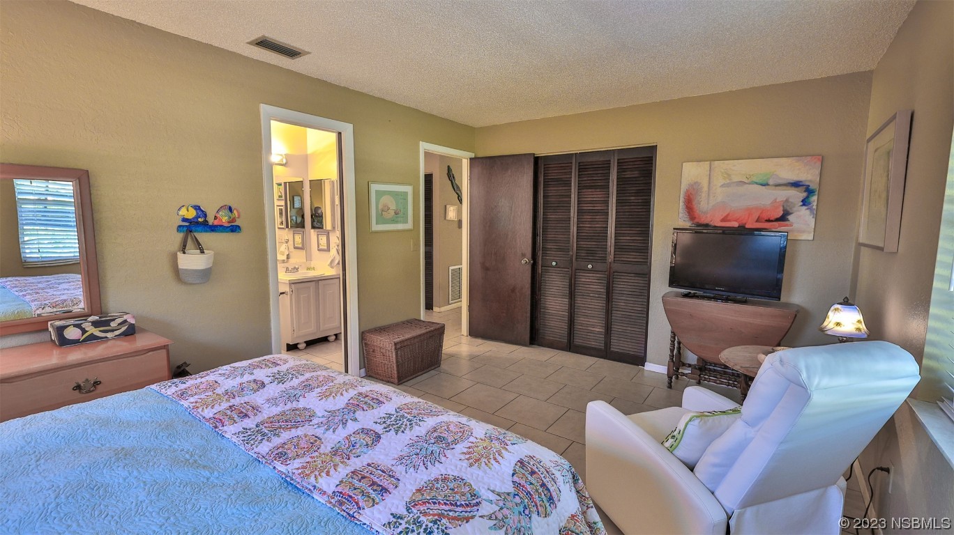 1861 Evergreen Drive Edgewater, FL 32141 - Photo 19 of 31 a bedroom with a bed and furniture