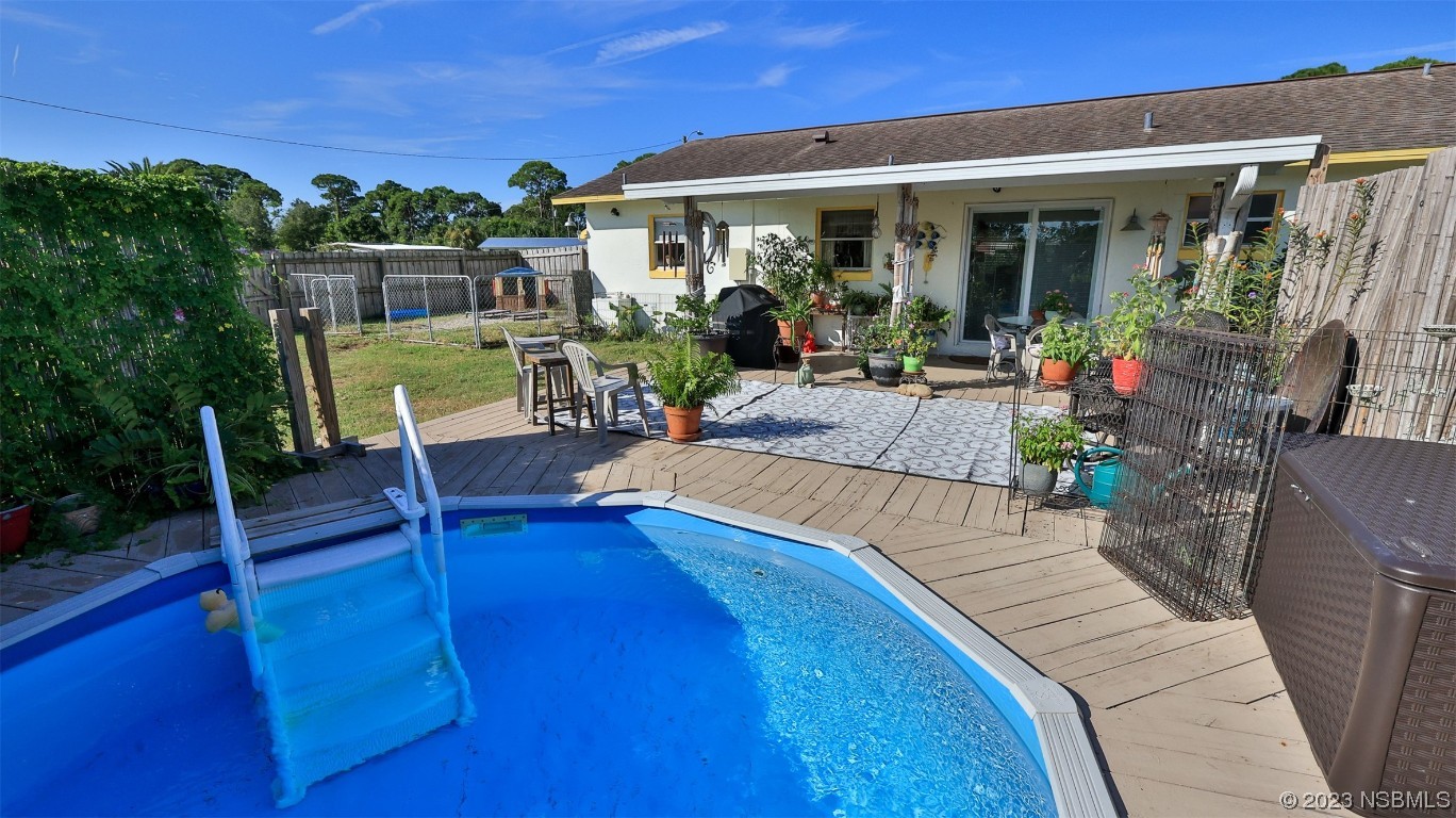 1861 Evergreen Drive Edgewater, FL 32141 - Photo 26 of 31 a view of a chairs and table in patio with a fireplace