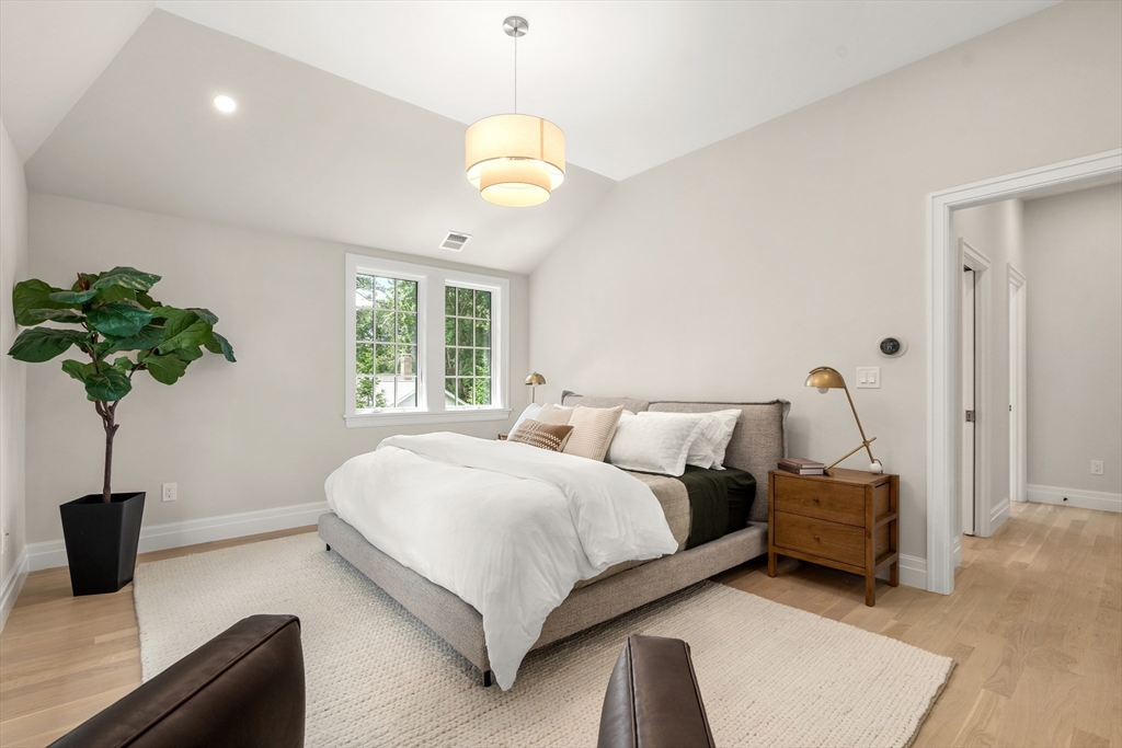 28 Parker Road Wellesley, MA 02482 - Photo 18 of 32 a bedroom with a bed and a potted plant