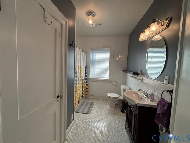 a bathroom with a mirror a sink and a mirror