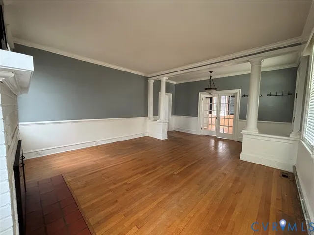 wooden floor in an empty room with a window