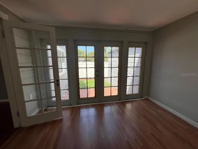 wooden floor in an empty room with a window