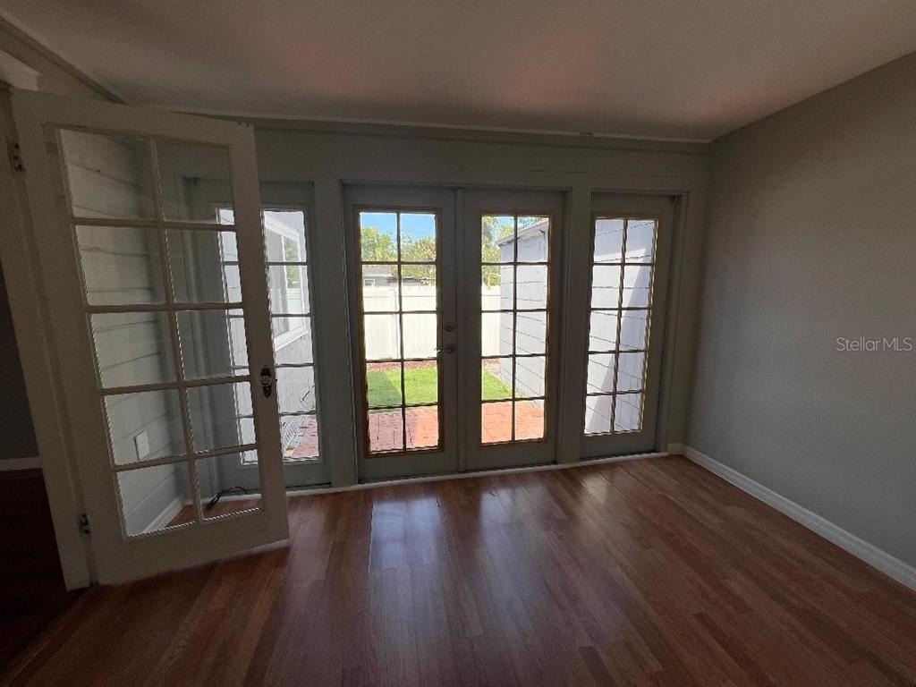 Undisclosed Address Tampa, FL 33609 - Photo 6 of 7 wooden floor in an empty room with a window