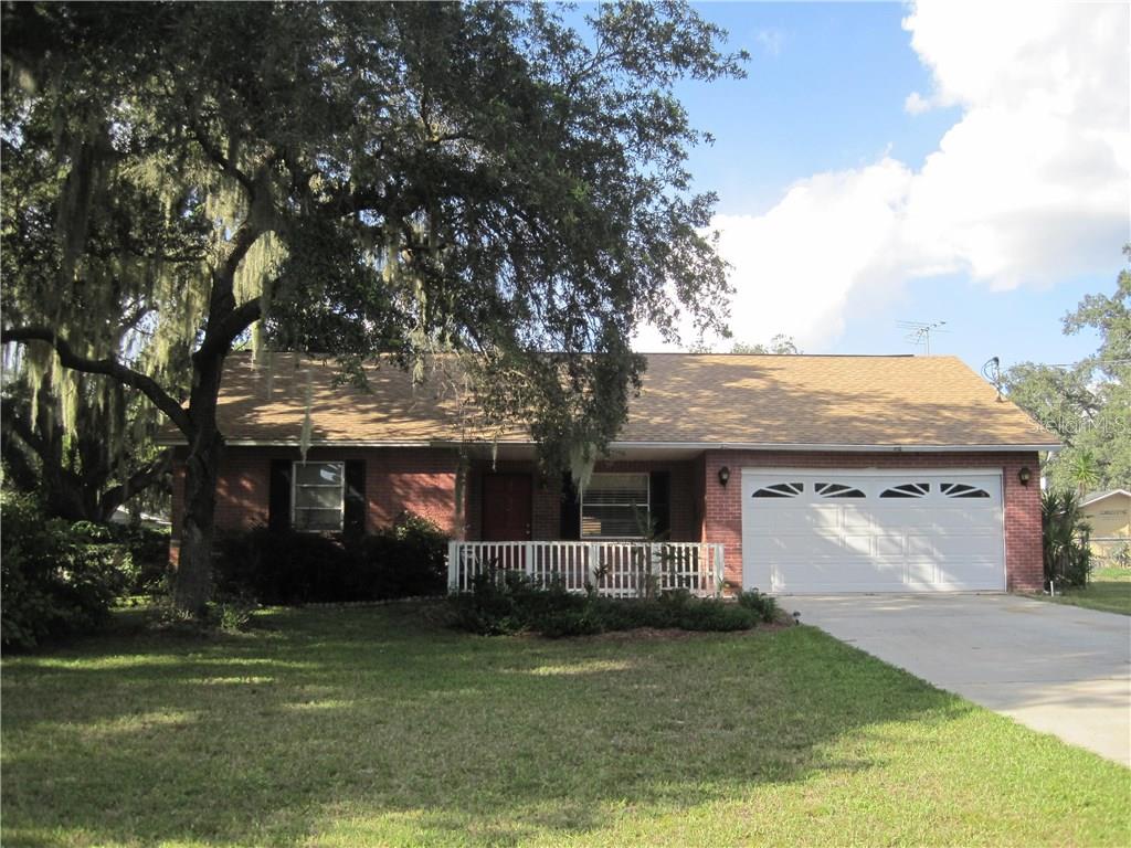 11214 Rice Creek Road Riverview, FL 33569 - Photo 1 of 1 a front view of a house with a garden and trees