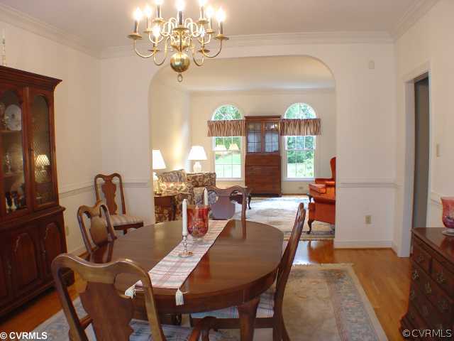 14441 Newgate Road Midlothian, VA 23113 - Photo 3 of 10 a view of a dining room with furniture a chandelier and wooden floor