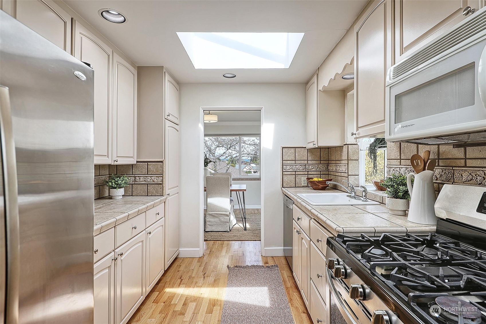 612 9th Avenue North Edmonds, WA 98020 - Photo 11 of 39 a kitchen with stainless steel appliances a stove a sink and a refrigerator