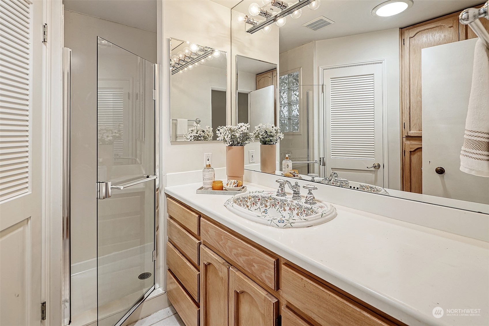 612 9th Avenue North Edmonds, WA 98020 - Photo 16 of 39 a bathroom with a granite countertop sink and a mirror