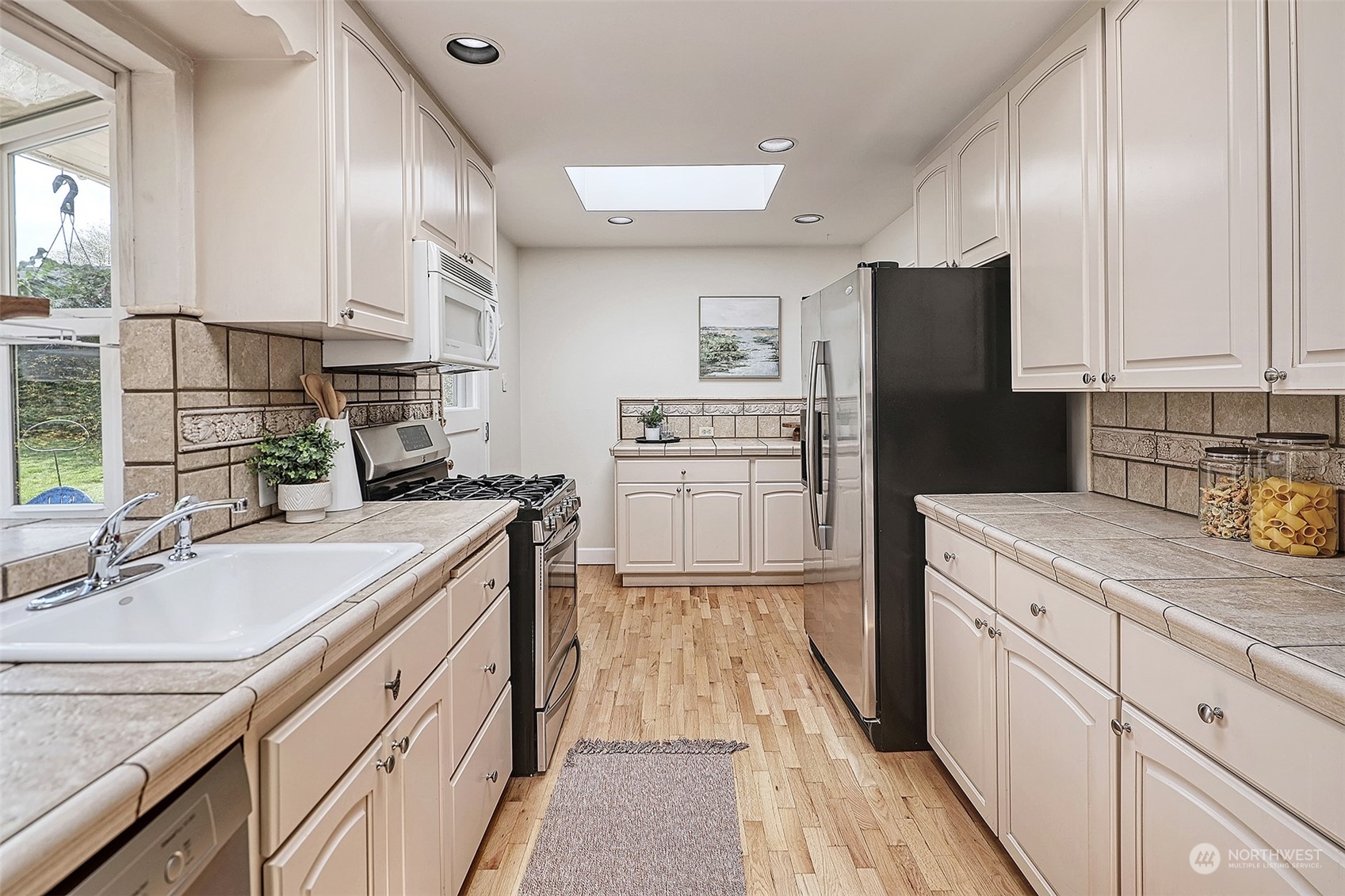 612 9th Avenue North Edmonds, WA 98020 - Photo 9 of 39 a kitchen with a sink stove and refrigerator