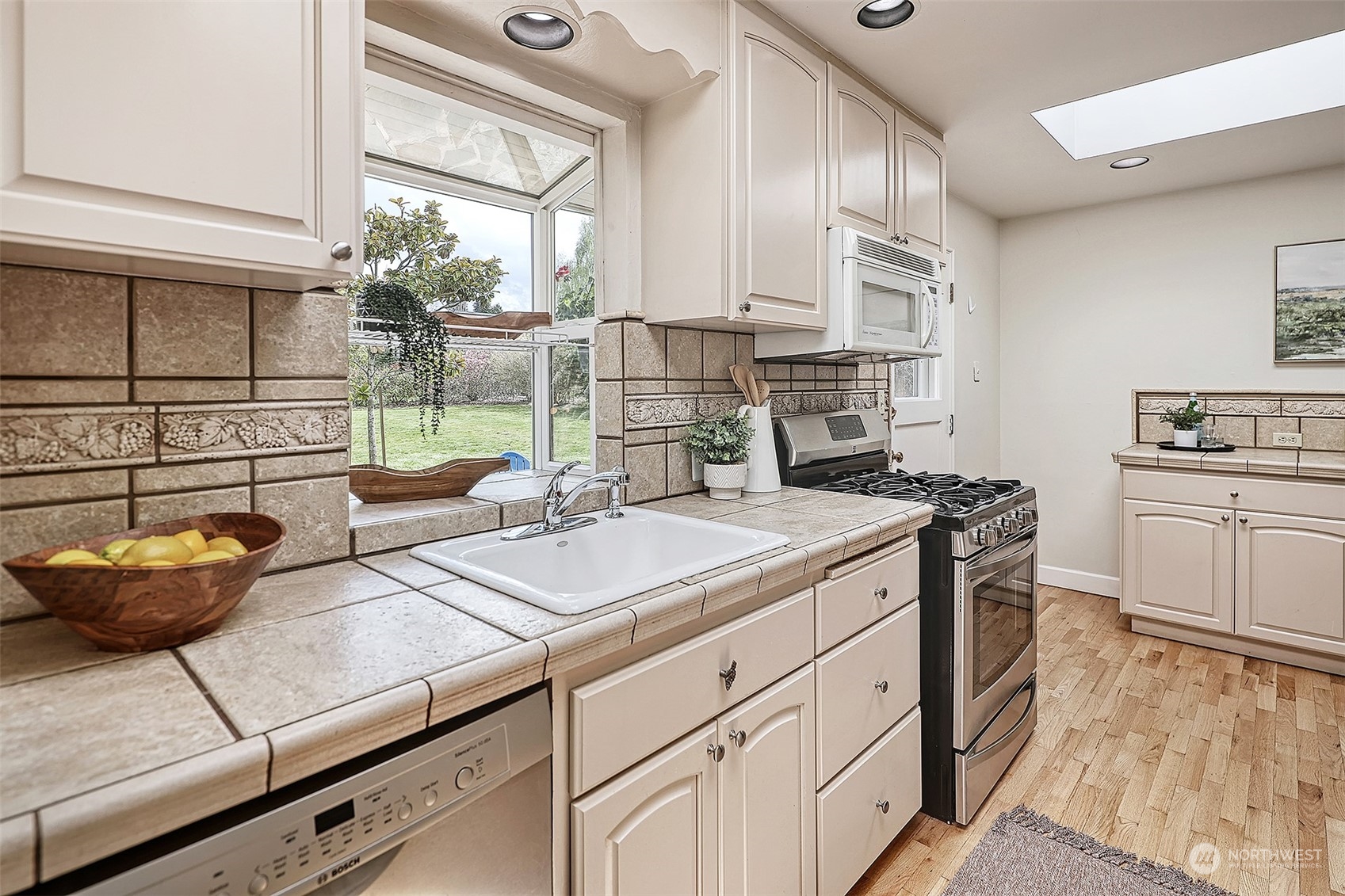612 9th Avenue North Edmonds, WA 98020 - Photo 10 of 39 a kitchen with a sink stove and cabinets