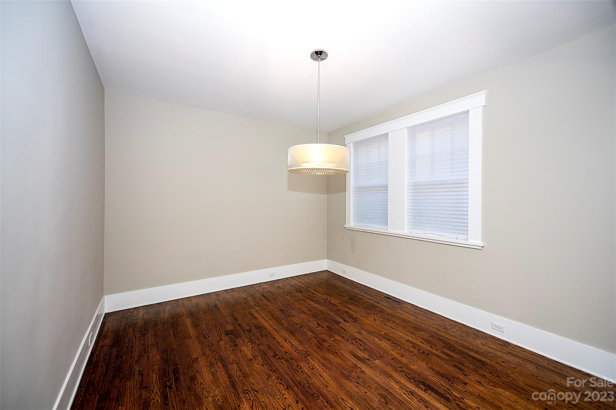 1403 Devon Drive Charlotte, NC 28209 - Photo 14 of 46 a view of an empty room with wooden floor and a window