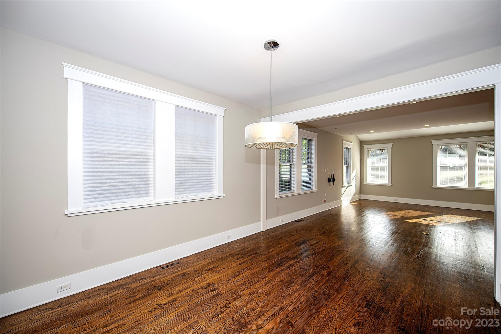1403 Devon Drive Charlotte, NC 28209 - Photo 16 of 46 a view of an empty room with wooden floor and a window