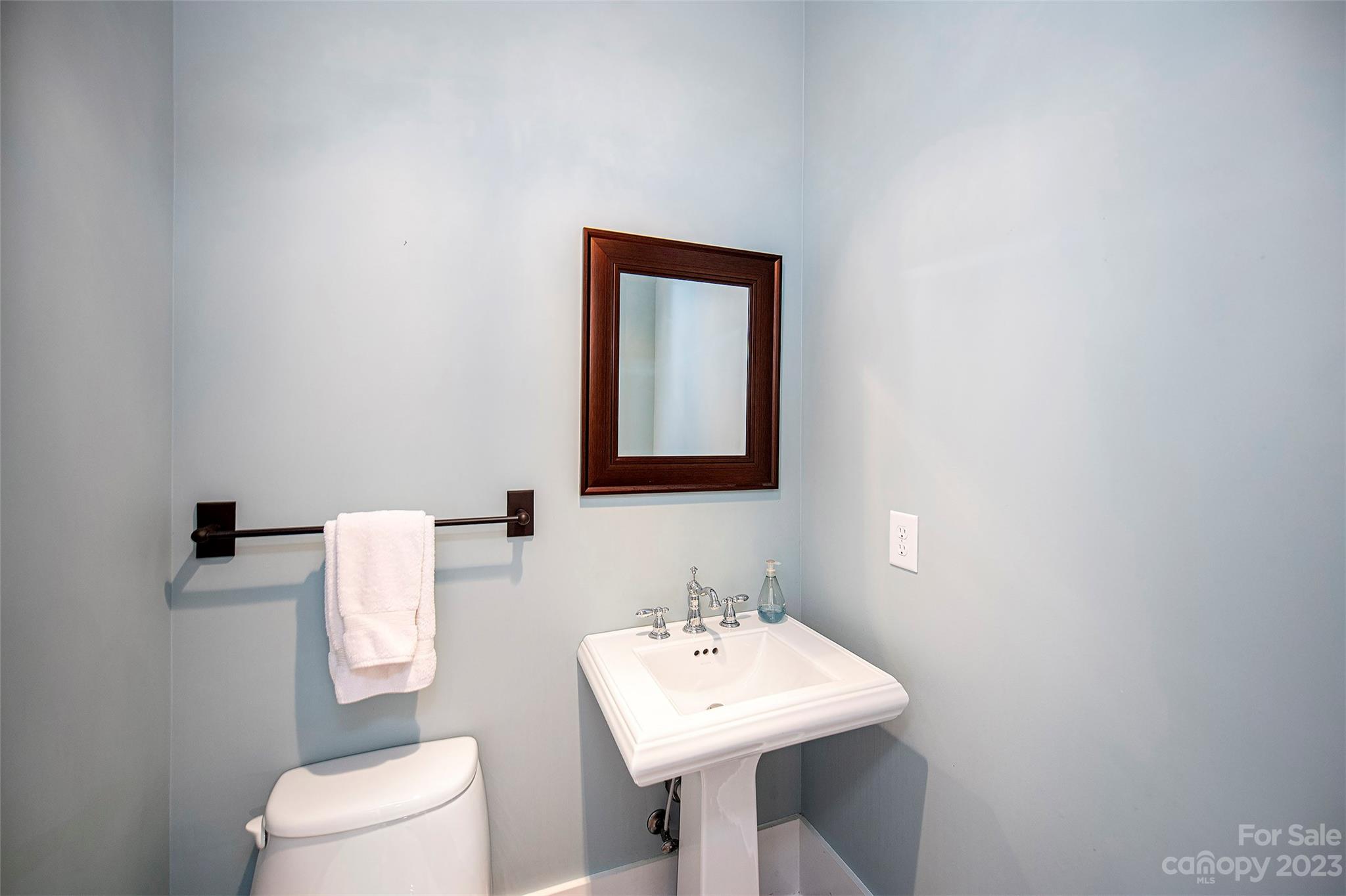1403 Devon Drive Charlotte, NC 28209 - Photo 20 of 46 a bathroom with a toilet sink and mirror