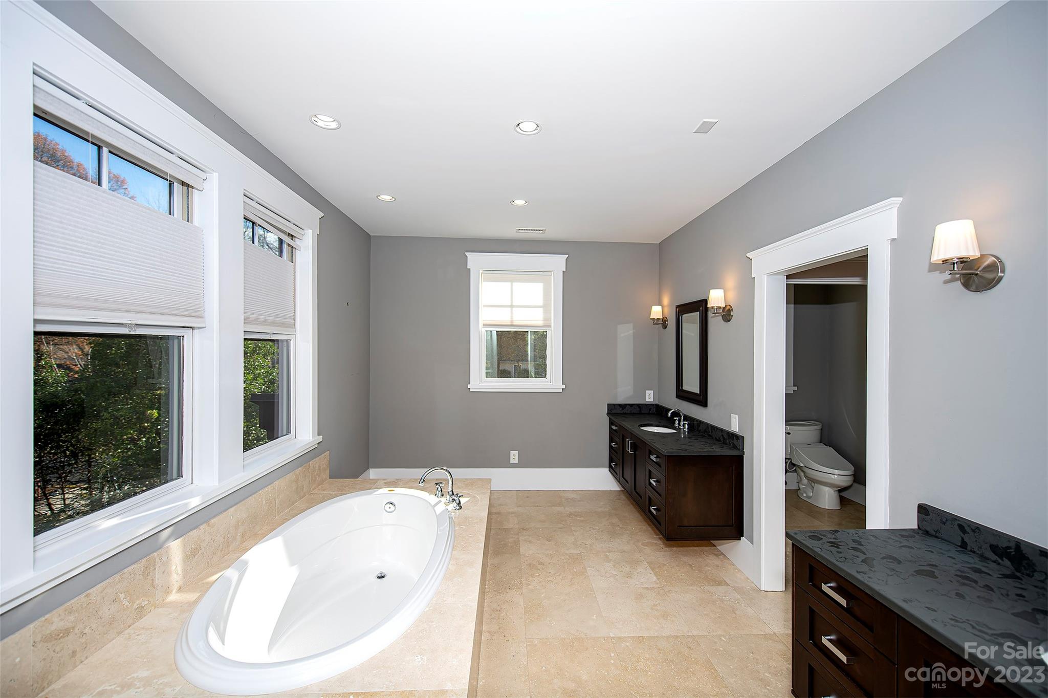 1403 Devon Drive Charlotte, NC 28209 - Photo 30 of 46 a bathroom with a tub sink and mirror