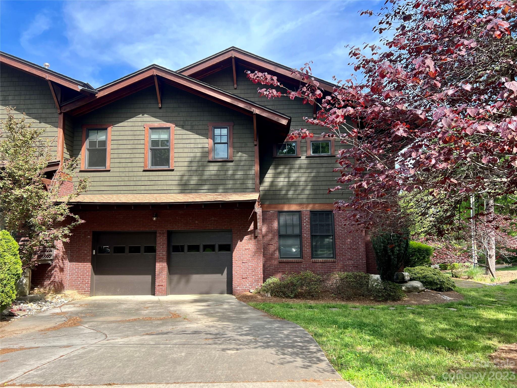 1403 Devon Drive Charlotte, NC 28209 - Photo 3 of 46 a front view of a house with a garden and yard