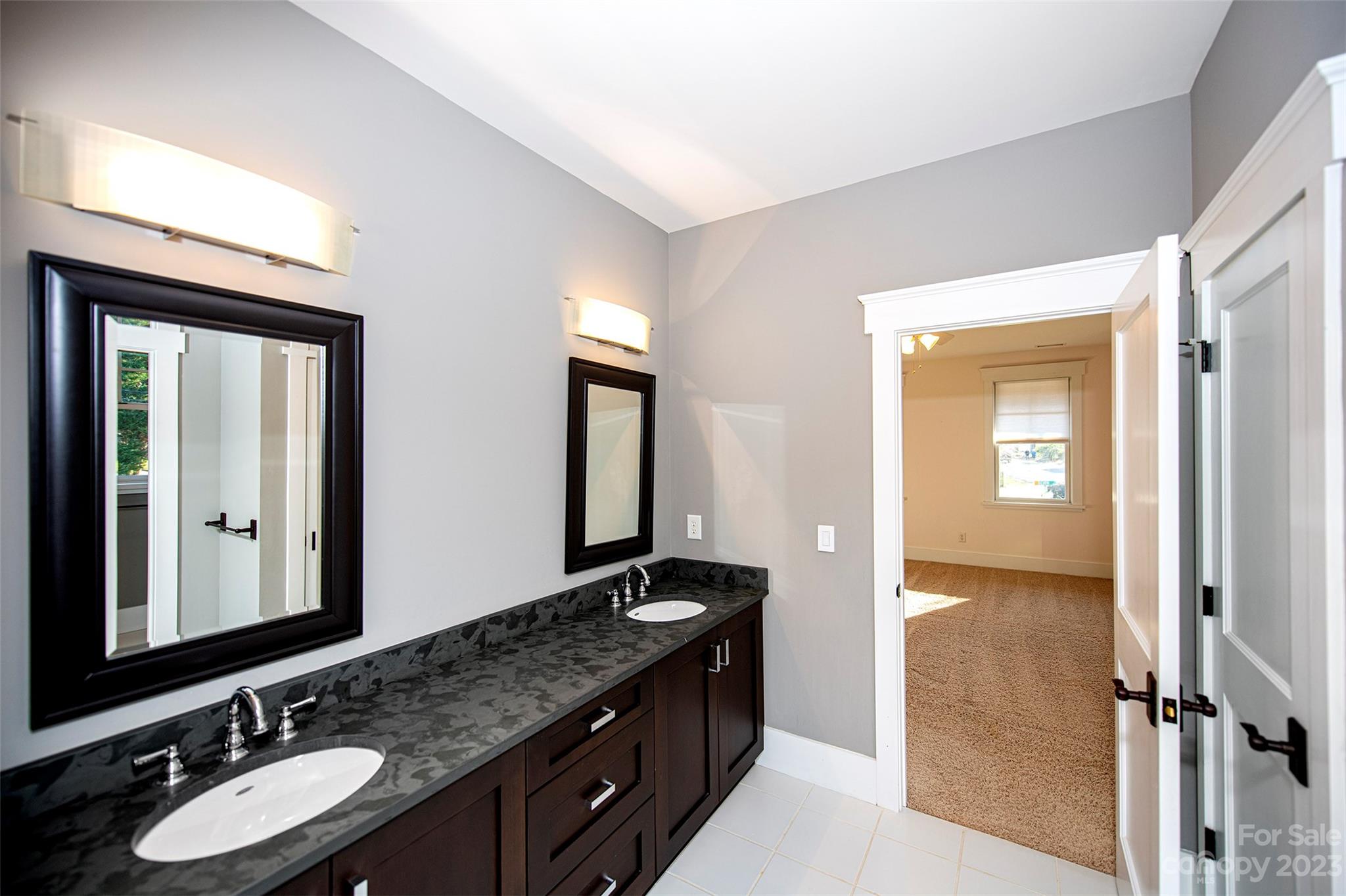 1403 Devon Drive Charlotte, NC 28209 - Photo 38 of 46 a bathroom with a granite countertop sink and a mirror