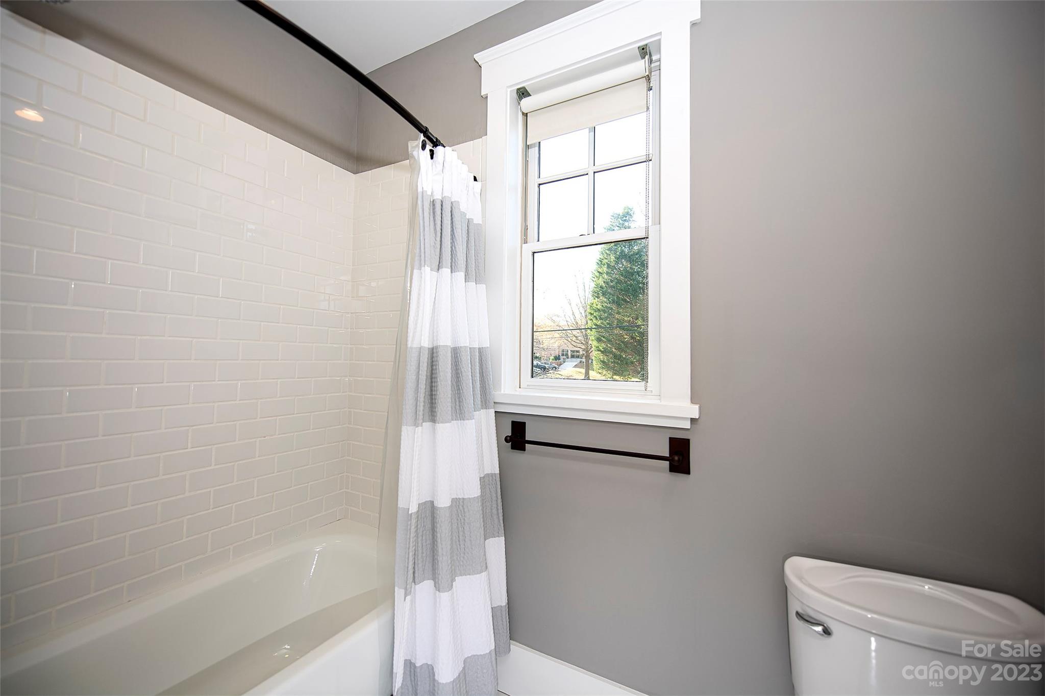 1403 Devon Drive Charlotte, NC 28209 - Photo 39 of 46 a bathroom with a shower a toilet and a window