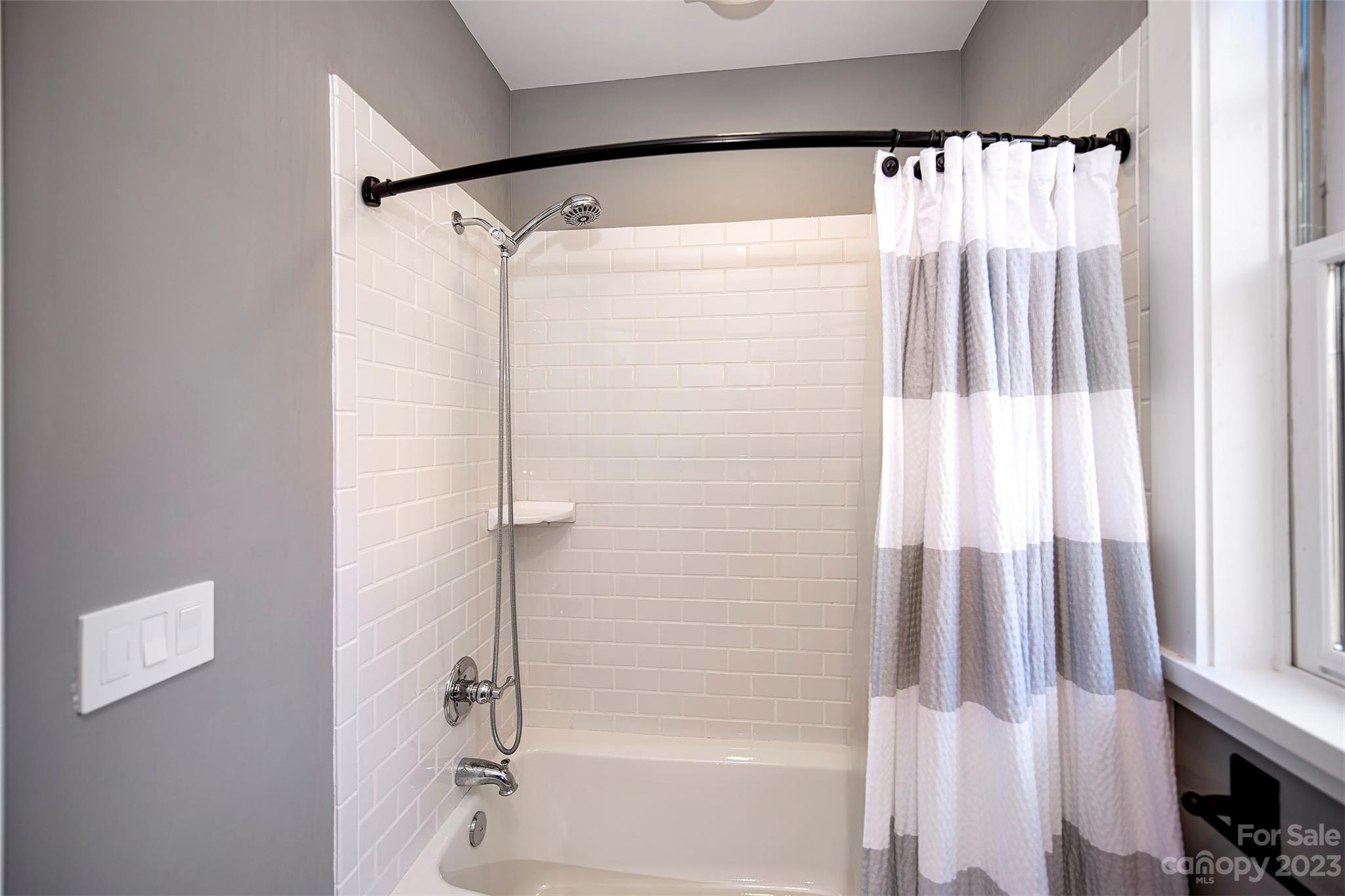 1403 Devon Drive Charlotte, NC 28209 - Photo 40 of 46 a bathroom with a shower and a tub