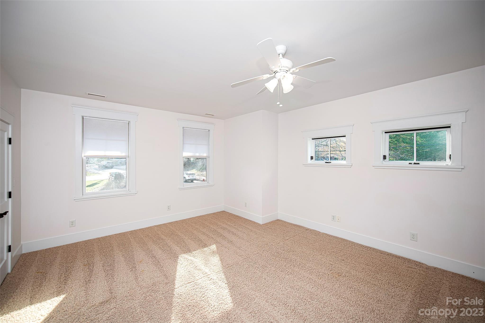 1403 Devon Drive Charlotte, NC 28209 - Photo 41 of 46 a view of a big room with windows and chandelier fan