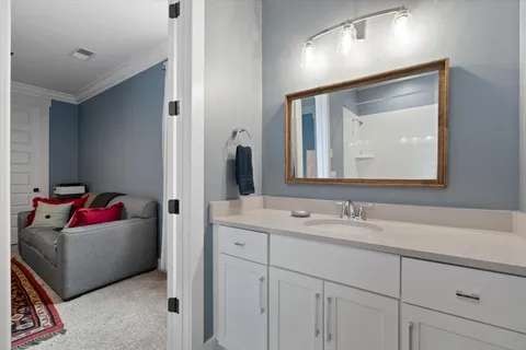 a en suite bathroom with a sink and a mirror