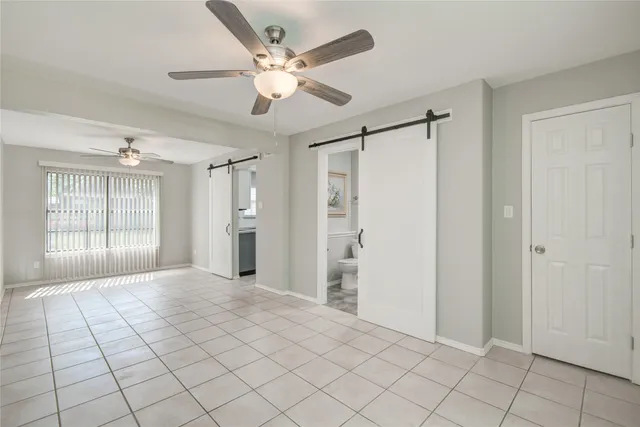 a view of a livingroom with a ceiling fan and window
