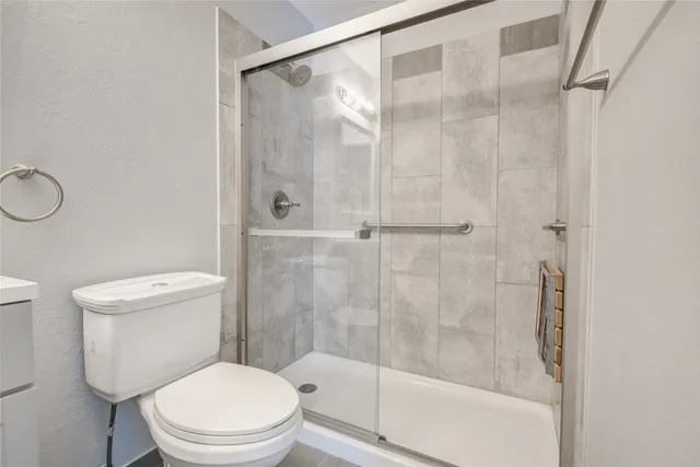 a white toilet sitting next to a bathroom sink