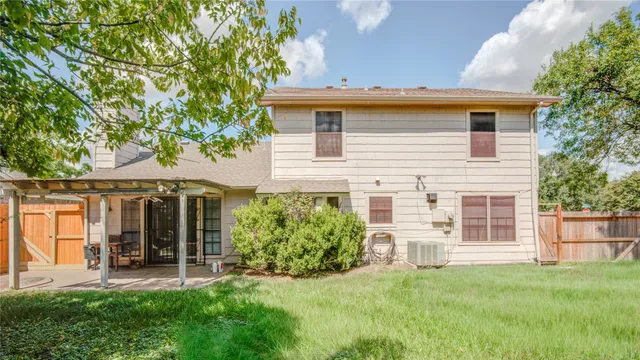 a view of a house with a yard and sitting area