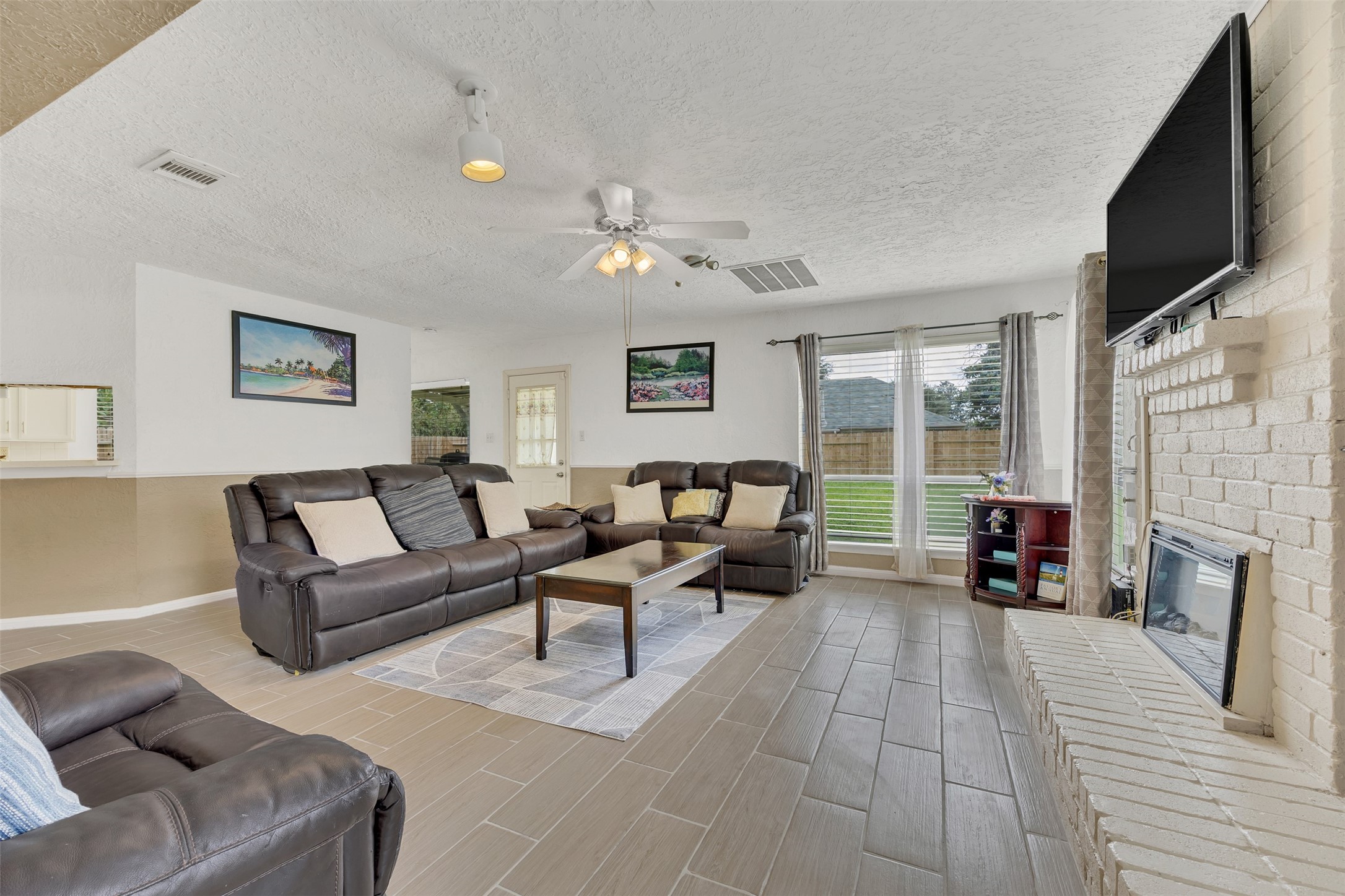 15619 Beechnut Street Houston, TX 77083 - Photo 11 of 29 Bright and inviting family room with large windows overlooking the backyard—perfect for relaxing or movie nights.