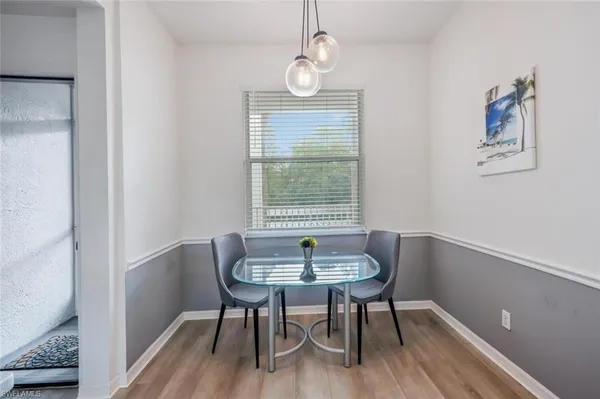 a dining room with furniture and window