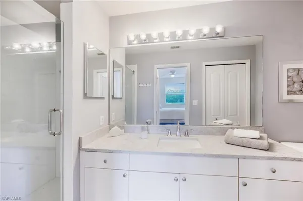 a bathroom with a sink double vanity and a mirror