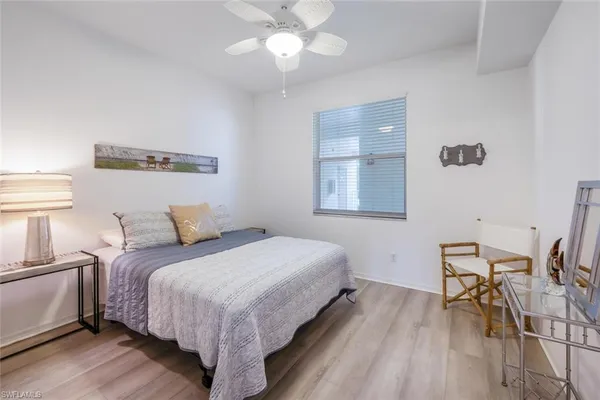 a bedroom with bed and a table